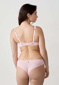 Roze lingerieset met een gladde textuur, verstelbare bandjes en een strikaccent op de achterkant van de beha, met een sleutelgatdetail op de slip.