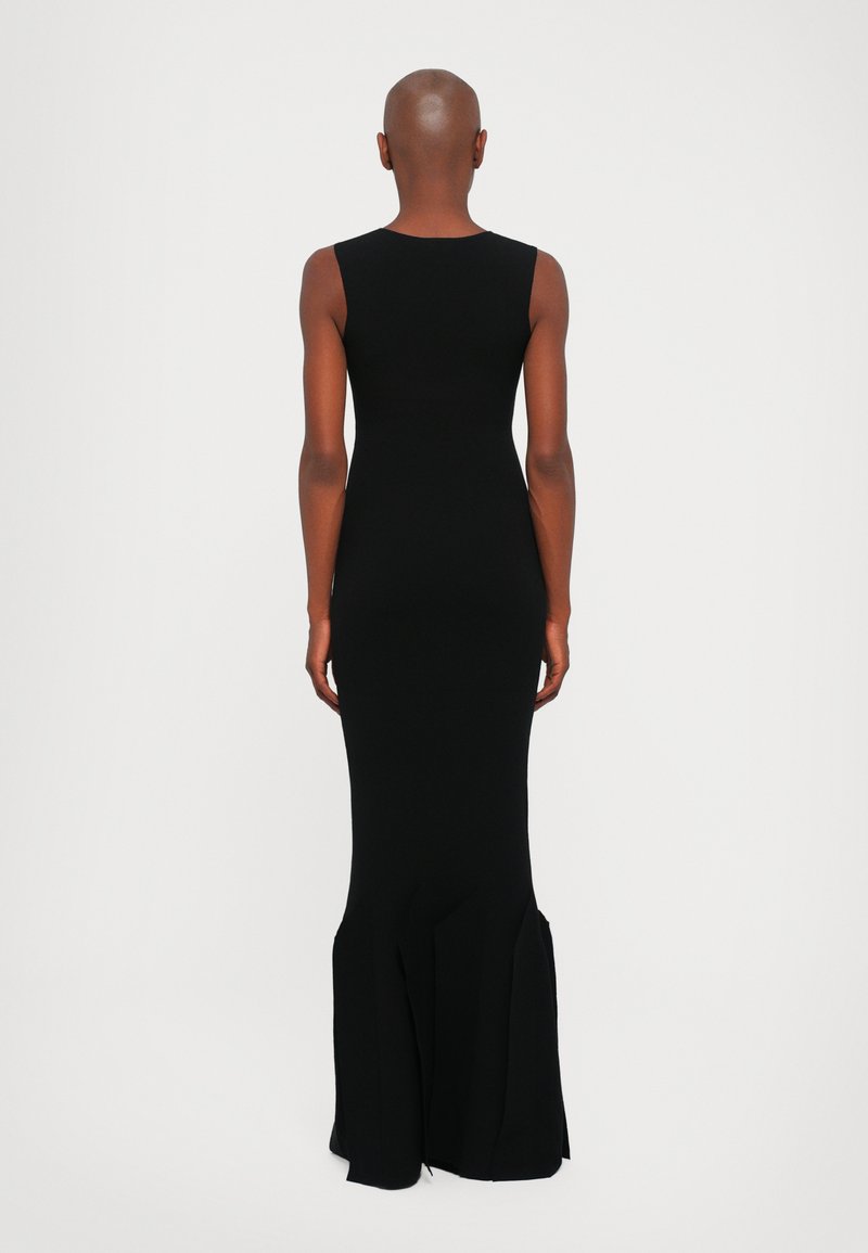 Black, sleeveless fitted gown with a flared hem, featuring a smooth texture and streamlined silhouette. Rear view showcases the elegant design.
