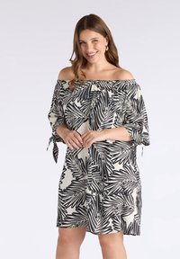 Vestido off-the-shoulder en crema con patrón de hojas negras, con mangas cortas, detalles de corbata y un escote elástico para mayor comodidad.
