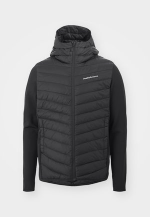 Black hooded jacket featuring a quilted front and smooth sleeves, made from a blend of materials. Logo on the upper left side.