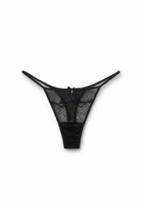 String noir en dentelle avec des panneaux en mesh transparent et un motif floral, des fines bretelles et un petit nœud en accent à l'arrière.
