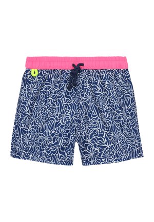 Short de bain bleu marine à motifs floraux blancs, taille élastique rose vif, cordon noir et petite boucle jaune fluo sur le côté gauche.