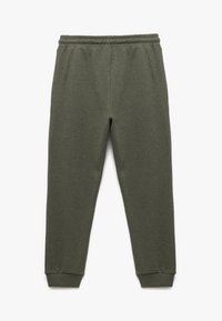 Donkergroene sweatpants met een elastische tailleband, ribgebreide manchetten en een gestructureerde stof. Geen zakken, met een recht model.