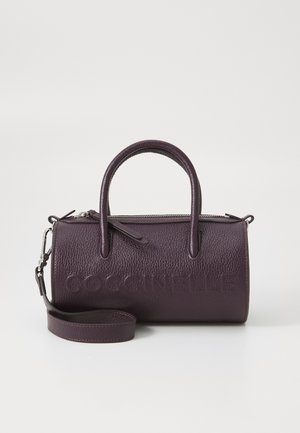 Purple leather handbag with two top handles, a zip closure, and an adjustable strap. Features embossed brand name. Textured finish.