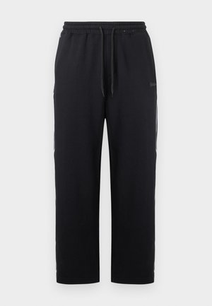 Črne joggerske hlače iz bombažne mešanice, z elastičnim pasom in vrvico, stranskimi žepi in ravnimi hlačnicami.