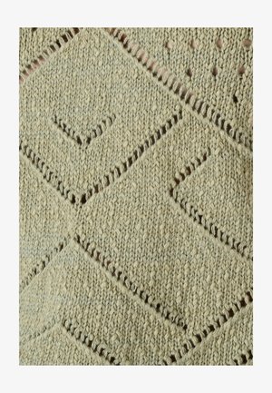 Tela tejida con patrones en forma de diamante y pequeñas perforaciones en hilo beige, mostrando textura y detalles de puntadas.