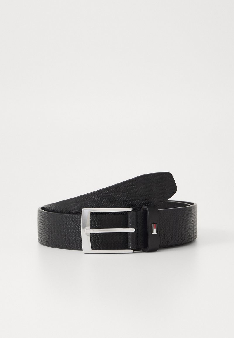 Black synthetic belt with a textured finish, featuring a silver metal buckle and a rectangular logo accent. Flat design with a smooth edge.