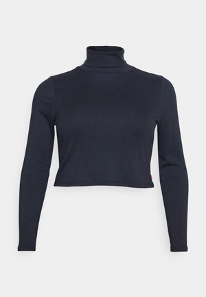 Marineblå ribbestrikket langermet turtleneck med en cropped design og en tettsittende silhuett. Har et subtilt, teksturert stoff.