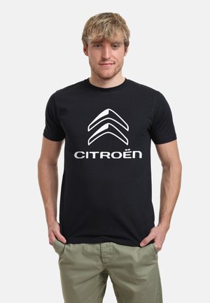 Schwarzes Baumwoll-T-Shirt mit weißem Citroën-Logo. Kurze Ärmel, Rundhalsausschnitt und taillierte Passform. Leichte und glatte Textur.