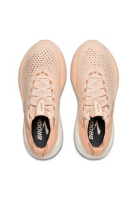 Light peach running shoes with a mesh upper, textured laces, and a white sole; features brand logo inside and side accents.