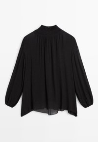 Blouse noire avec un col montant smocké, des manches longues bouffantes et une coupe ample. Confectionnée en tissu léger et texturé.