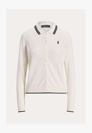 Cremfarbener Cardigan mit Knopfleiste, gerippten Bündchen und einem navy gestreiften Kragen. Mit einem dezenten navy Logo auf der linken Brust.