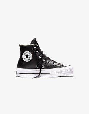 Zapatilla Converse All Star negra de cuero alto con suela blanca, cordones negros y parche circular con logo en el tobillo, vista lateral.