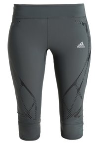 Szare legginsy sportowe wykonane z elastycznego materiału, z czarnymi abstrakcyjnymi wzorami oraz logo Adidas z przodu. Długość do połowy łydki, dopasowany krój.