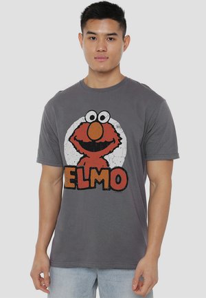 Gray cotton t-shirt featuring an illustration of Elmo in red, with large eyes and orange nose, and the word "ELMO" in bold, distressed letters.