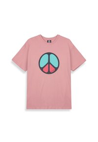 Camiseta de algodón rosa con un gran gráfico de símbolo de paz negro en turquesa y rojo. Mangas cortas, cuello redondo, corte relajado.