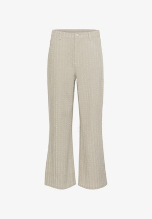 Pantaloni bej evazați cu un model texturat în chenar, având un sistem de închidere cu buton frontal și buzunare. Materialul pare moale, cu un ușor luciu.