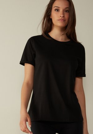 Black short-sleeve t-shirt made from soft material with a round neckline and a relaxed fit, featuring a smooth texture and simple design.