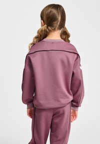 Paarse sportieve sweatshirt en broek set met lange mouwen, ronde halslijn en contrasterende zwarte piping langs de schouders en zijkanten.
