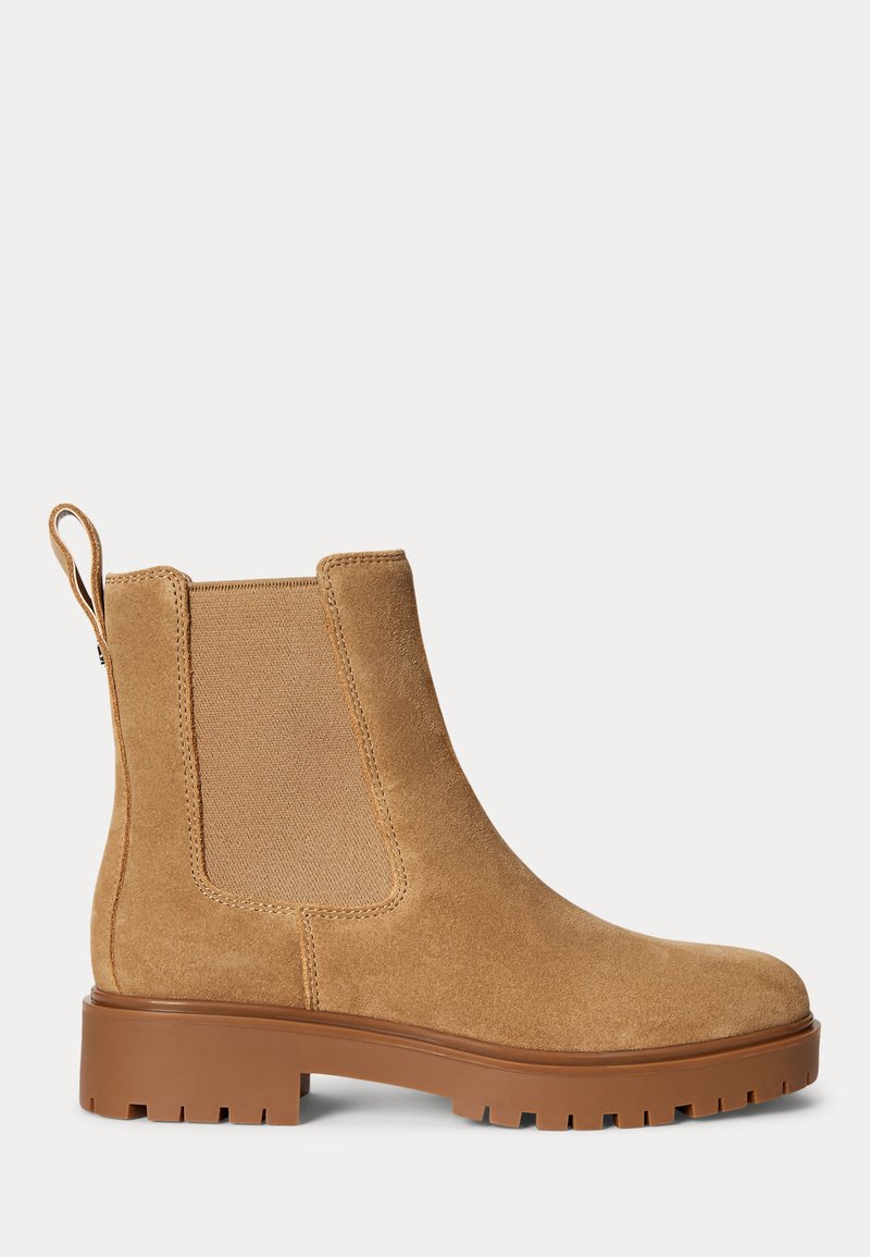 Tan suede Chelsea boot with elastic side panels, pull tab at back, and thick brown rubber lug sole.