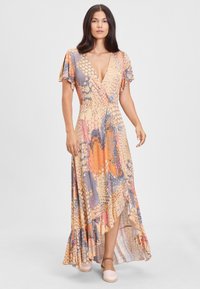 Maxi šaty s tropickým vzorom v oranžových, modrých a béžových odtieňoch. Výstrih do V, volánové rukávy a riasený lem. Vyrobené z mäkkej látky.