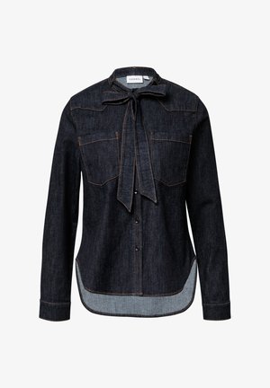 Dark denim shirt with a tie neck, two chest pockets, contrasting orange stitching, and a curved hem with a lighter denim underside.