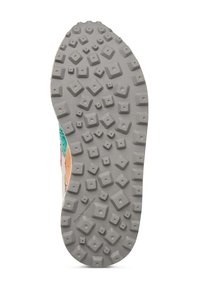 Shoe sole features a textured gray rubber with multidirectional lugs and varying shapes for traction, including squares and rectangles.