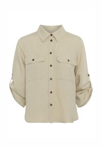 Camicia di lino beige con colletto, chiusure frontali con bottoni, due tasche sul petto con alette e maniche arrotolate. Texture liscia.