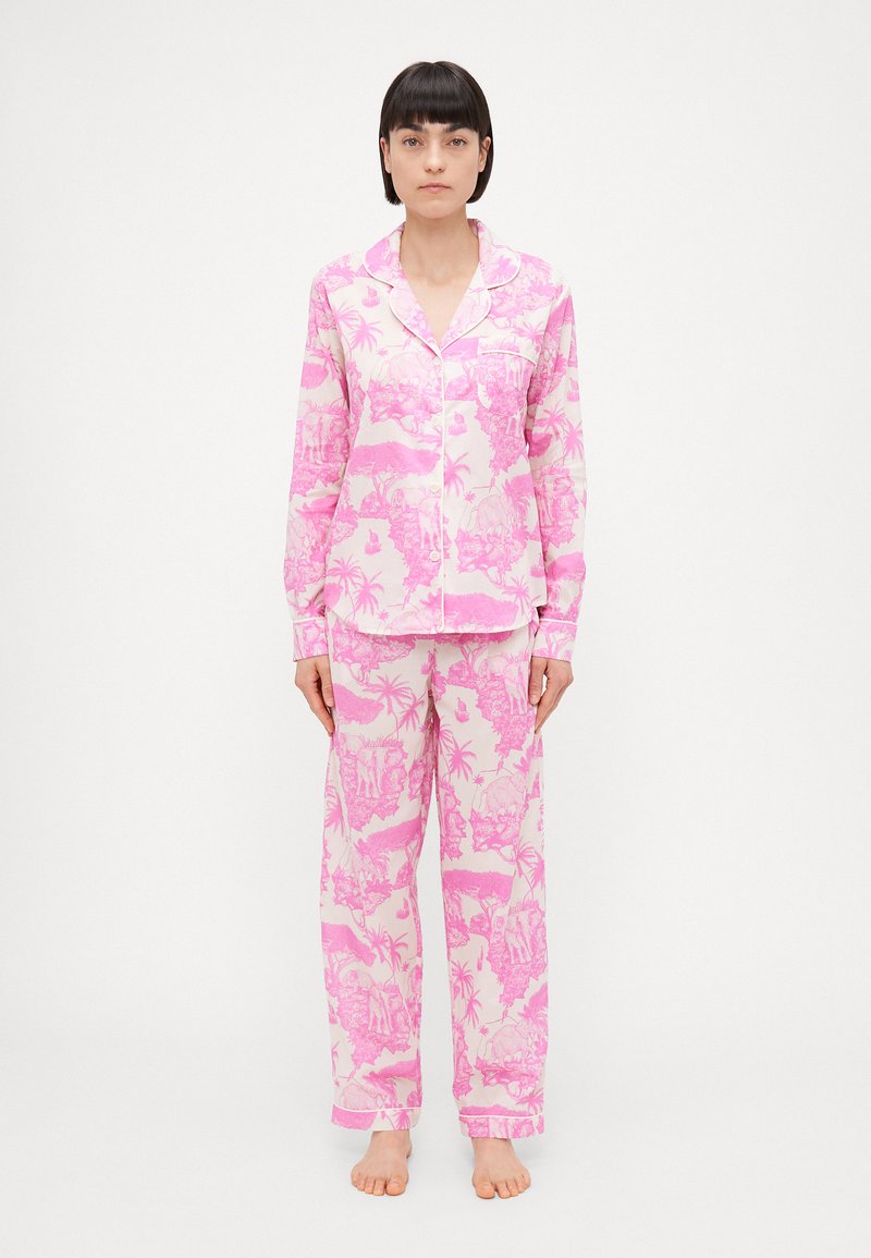 Pink pajama set featuring a tropical design with palm trees and figures, made of soft fabric, long sleeves, and loose-fitting pants.