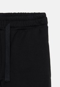 Black sweatpants featuring a soft, cotton blend fabric, an elastic waistband with a drawstring, and a smooth texture.