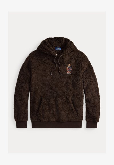 Brown fleece hoodie with a textured, fluffy design. Features a front pocket and an embroidered bear logo on the left chest.