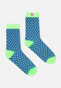 Marineblaue Socken mit neongrünen Punkten, solidem grünem Bund und einem lächelnden Emoji-Akzent am Bund. Hergestellt aus weichem, dehnbarem Material.