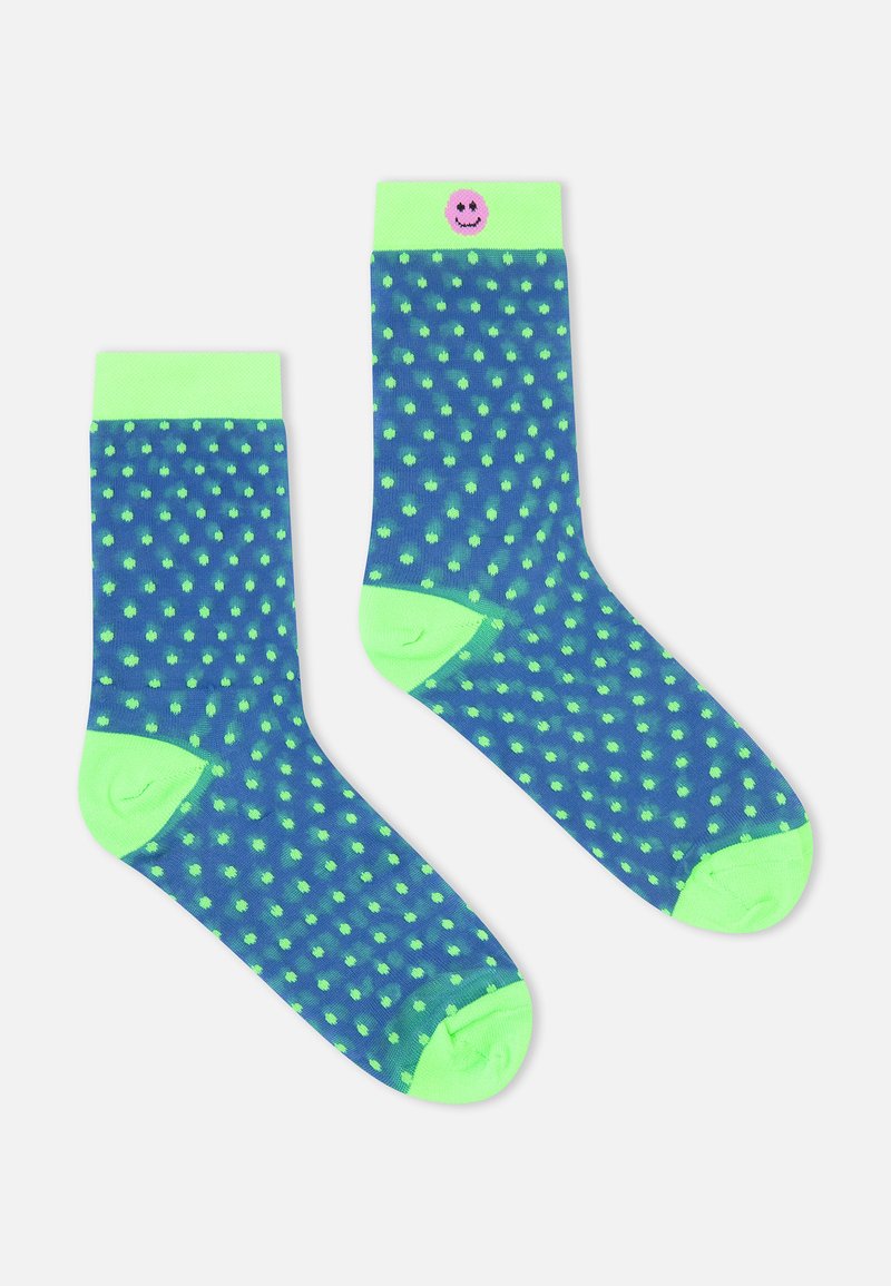 Marineblaue Socken mit neongrünen Punkten, solidem grünem Bund und einem lächelnden Emoji-Akzent am Bund. Hergestellt aus weichem, dehnbarem Material.