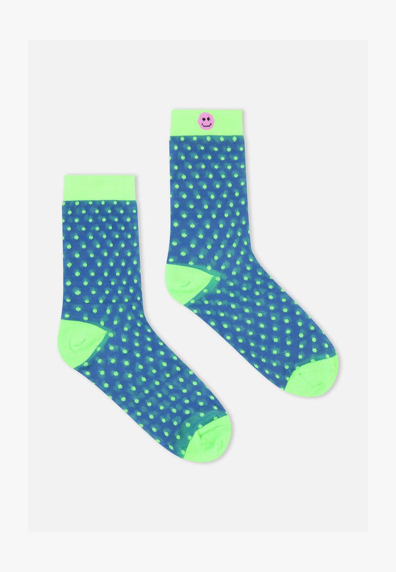 Marineblaue Socken mit neongrünen Punkten, solidem grünem Bund und einem lächelnden Emoji-Akzent am Bund. Hergestellt aus weichem, dehnbarem Material.