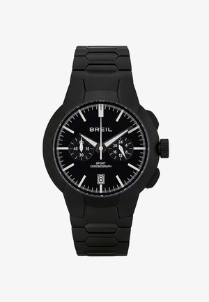 Czarny zegarek chronograf z teksturowanym paskiem silikonowym, dużą okrągłą kopertą, białymi znacznikami godzinowymi i tarczami pomocniczymi. Wyświetlacz daty na godzinie szóstej.