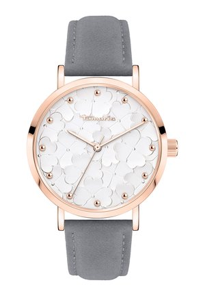 Round watch with a white textured dial featuring heart patterns, rose gold case, and grey suede strap. Minimalist design with crystal accents.