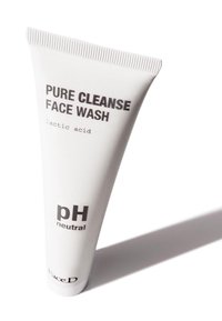 White plastic tube with a ribbed cap, labeled "Pure Cleanse Face Wash," displays "lactic acid" and "pH neutral" in black text.