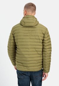 Olivengrøn quiltet jakke med horisontalt mønster, fastgjort hætte og elastiske ærmer. Har en glat, let ydre.