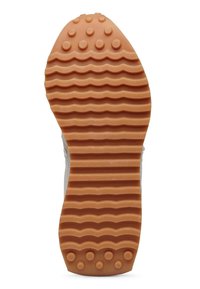 Sola di una sneaker con un motivo texturizzato e ondulato in gomma marrone chiaro, dotata di nodi di grip circolari e un bordo liscio.