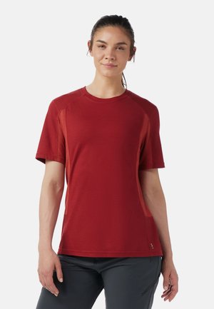 Red short-sleeve t-shirt made from breathable fabric, featuring a round neckline and textured side panels for improved ventilation.