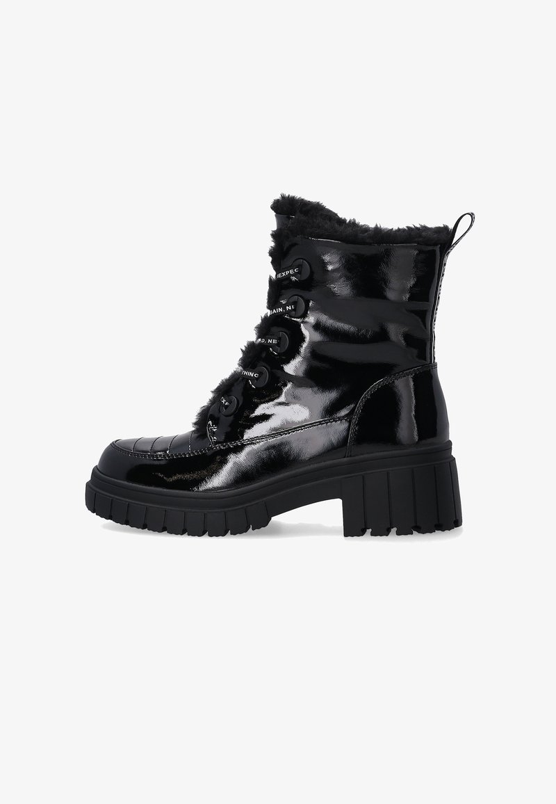 Black patent leather ankle boots with faux fur trim, lace-up design, chunky black heel, and textured rubber sole for traction.