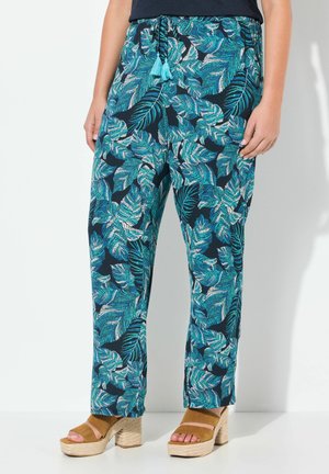 Pantalons floraux en bleu marine foncé avec un motif de feuilles vert vif et blanches, dotés d'une taille à cordon de serrage avec des franges turquoise.