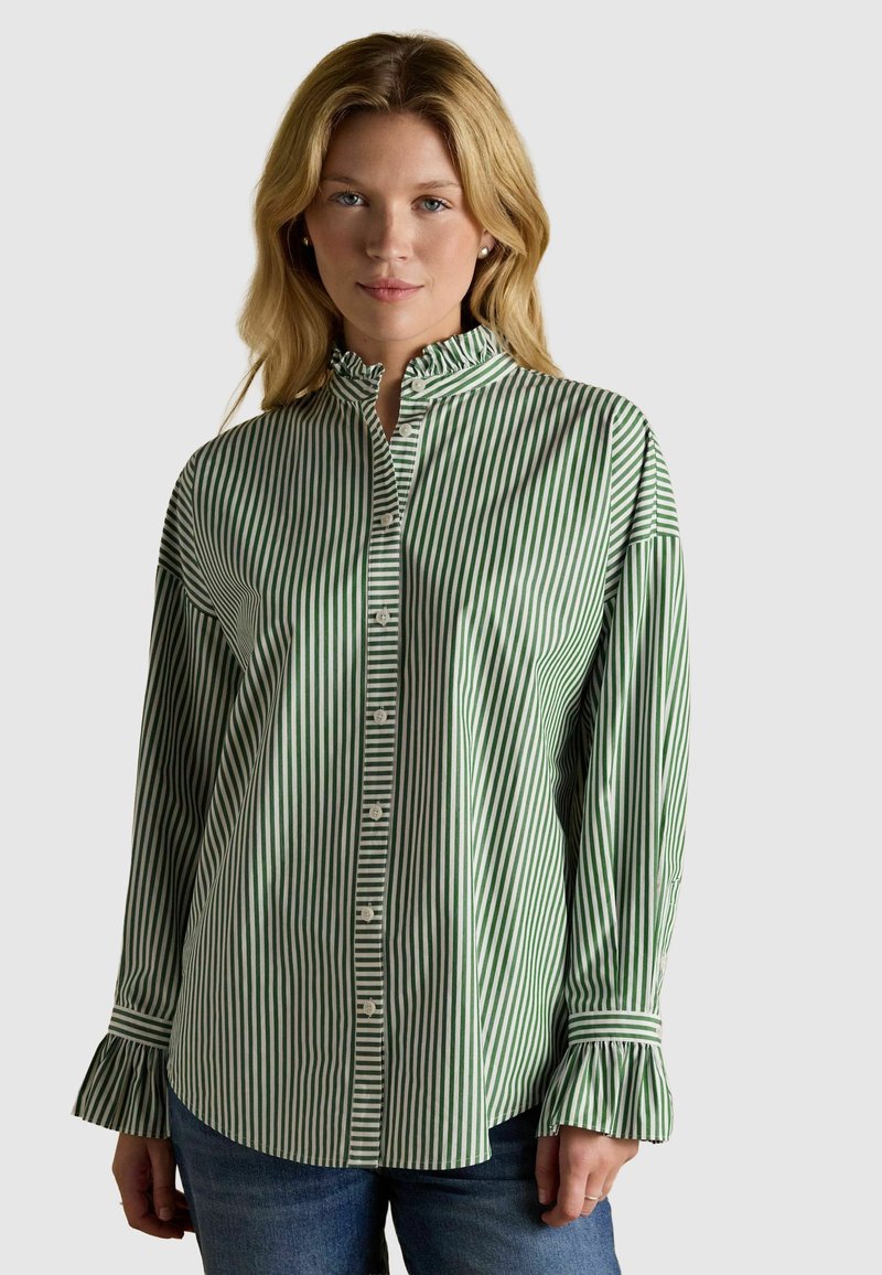 Cămașă cu dungi verzi și albe, cu guler și manșete volă, confecționată din țesătură de bumbac. Prezintă o croială lejeră și detalii subtile.