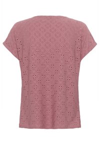 T-shirt rose à manches courtes avec un motif texturé brodé et des détails en ouvrant. Présente une coupe ample et un col rond.