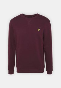 Sudadera burdeos hecha de tela suave, con cuello redondo, mangas largas y un pequeño logotipo amarillo en el pecho.