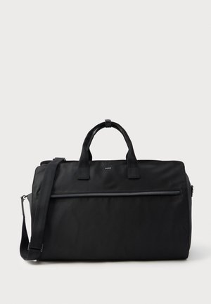 Black rectangular travel bag with dual handles, adjustable shoulder strap, front zipper pocket, and small "BOSS" logo on front.