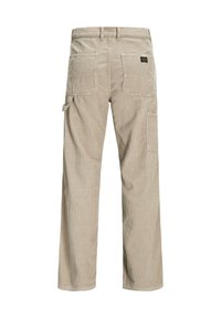 Beige corduroy pants with a loose fit, featuring two back pockets and a side pocket. Textured vertical stripes are visible.