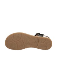Braune Außensohle aus strukturiertem Gummi mit gemusterten Rillen, entwickelt für Grip und Komfort. Verstellbarer schwarzer Riemen mit silberner Hardware.