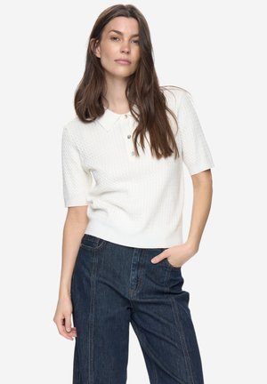 White short-sleeve sweater with a textured knit pattern and a polo collar. Features a button placket and a fitted waistband.