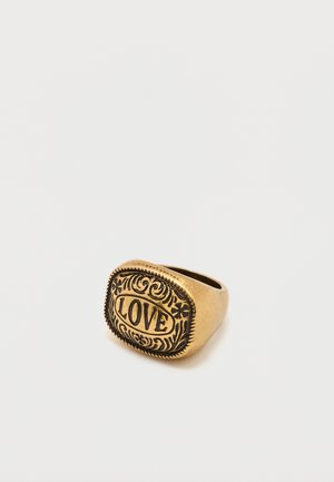 Gold-toned ring engraved with floral patterns and the word "LOVE" centered on a square face against a white background.